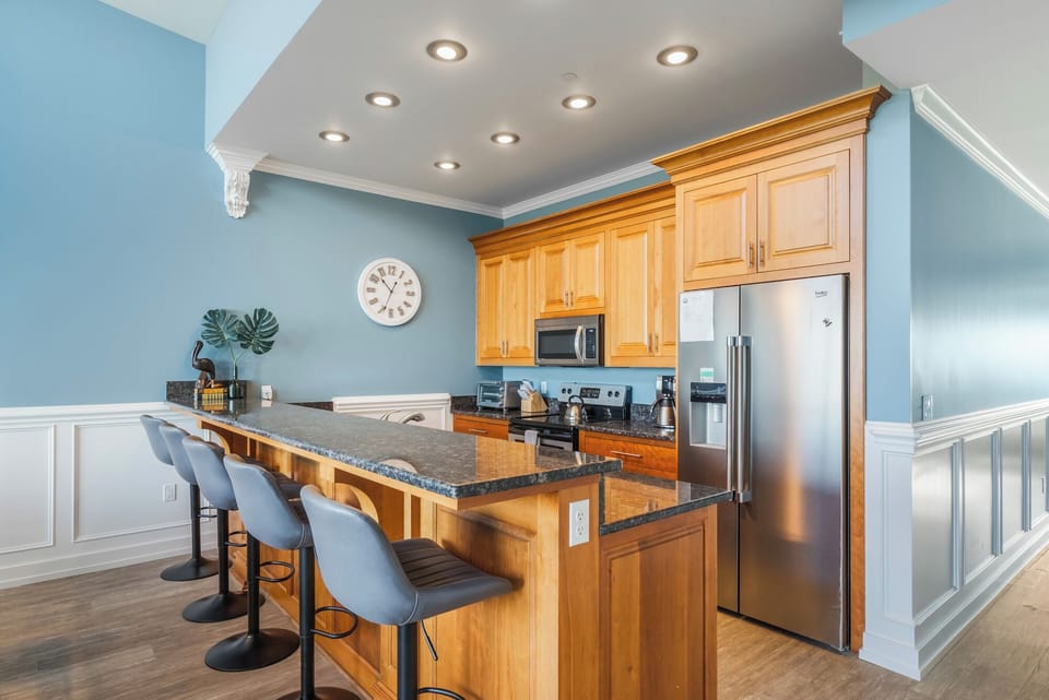 Fully equipped kitchen with granite countertops, stainless appliances.