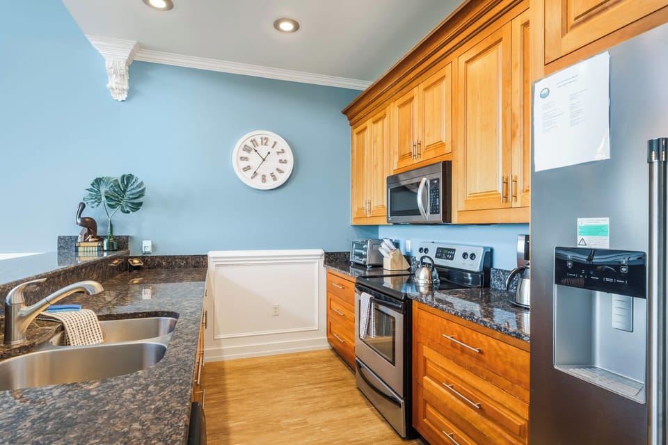 Bright kitchen with granite counters and ample cabinetry.