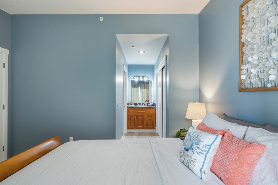 Bedroom view toward hallway and ensuite bathroom.