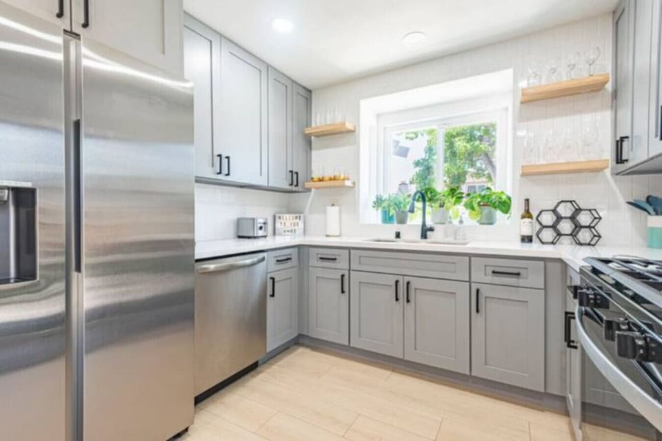 Kitchen fully stocked with high end appliances and kitchen utensils