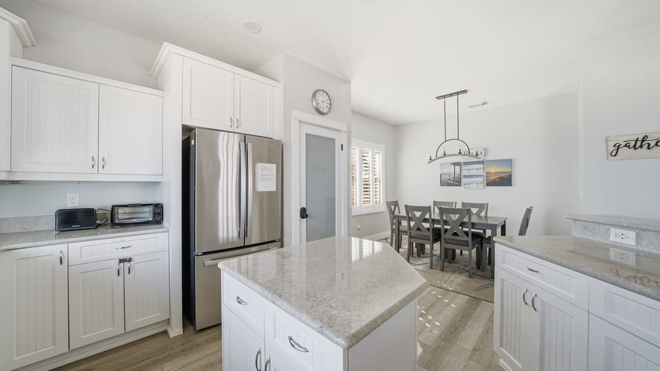 The modern kitchen sits within an open floorplan, creating a bright and connected space for gathering.