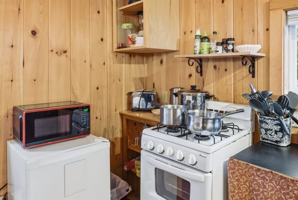 Prepare fresh trail meals on the premium 4-burner gas range. This intentional kitchenette includes a toaster, microwave, and mini-fridge to keep you fueled. Everything you need for a self-sufficient, pet-friendly Acadia National Park stay.