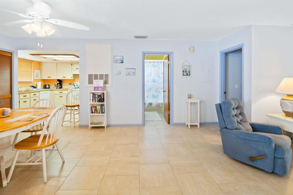 Relax in this airy beach stay featuring an open living and dining area, coastal décor, fully equipped kitchen, and tiled floors. Perfect for unwinding after a day at the beach, this inviting vacation rental offers comfort and convenience.