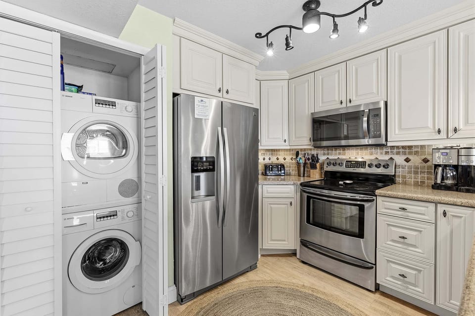 Enjoy the convenience of a modern coastal kitchen with stainless steel appliances and in-unit washer and dryer. Perfect for an extended beach stay with all the comforts of home near the ocean.
