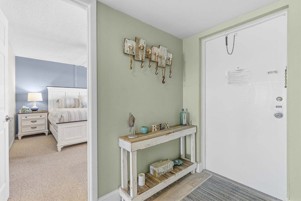 Step into comfort with this charming coastal entryway featuring beach-inspired décor and a relaxing atmosphere. Perfect for a stress-free beach stay just moments from the ocean and resort amenities.