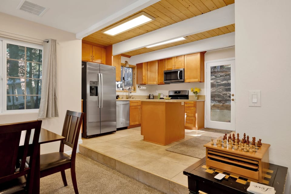 Fully equipped cabin kitchen with ample cabinetry, stove, fridge, microwave, and coffee maker—perfect for cooking meals, morning coffee, and feeling right at home on your stay.