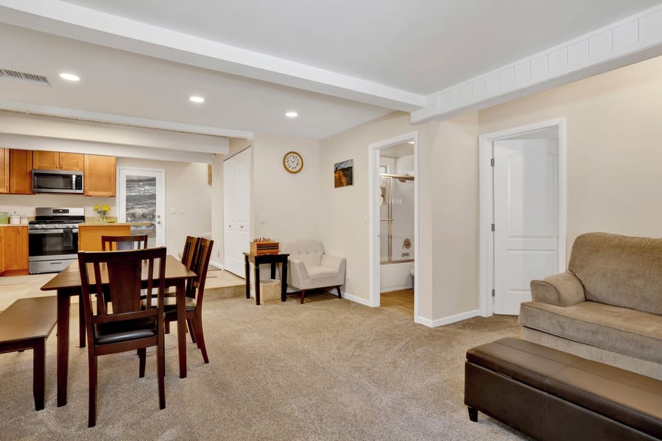 Cozy mountain living room with a stone fireplace, comfy seating, and smart TV—perfect for relaxing evenings, movie nights, and warm cabin vibes after outdoor adventures.