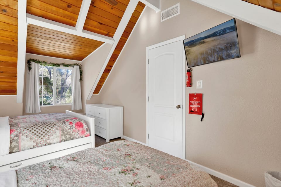 Peaceful cabin bedroom with plush bedding, and beautiful views—ideal for restful nights, cozy mornings, and a relaxing mountain escape.