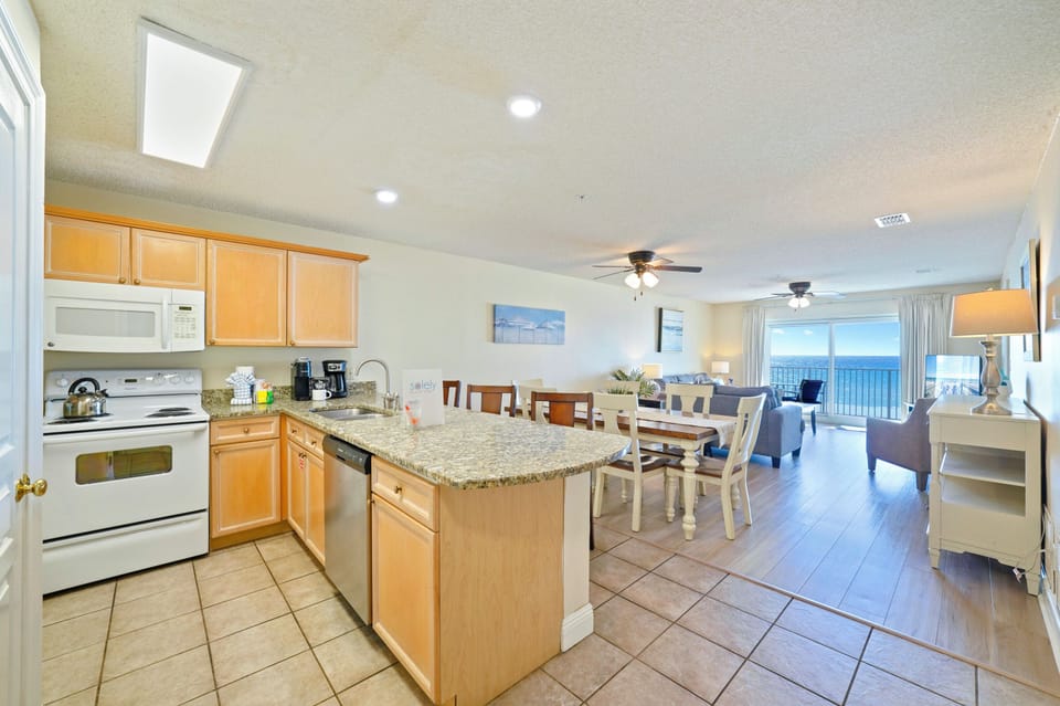 Prepare fresh seafood dinners in the fully equipped kitchen while sunlight pours in and emerald waters shimmer just beyond the balcony.