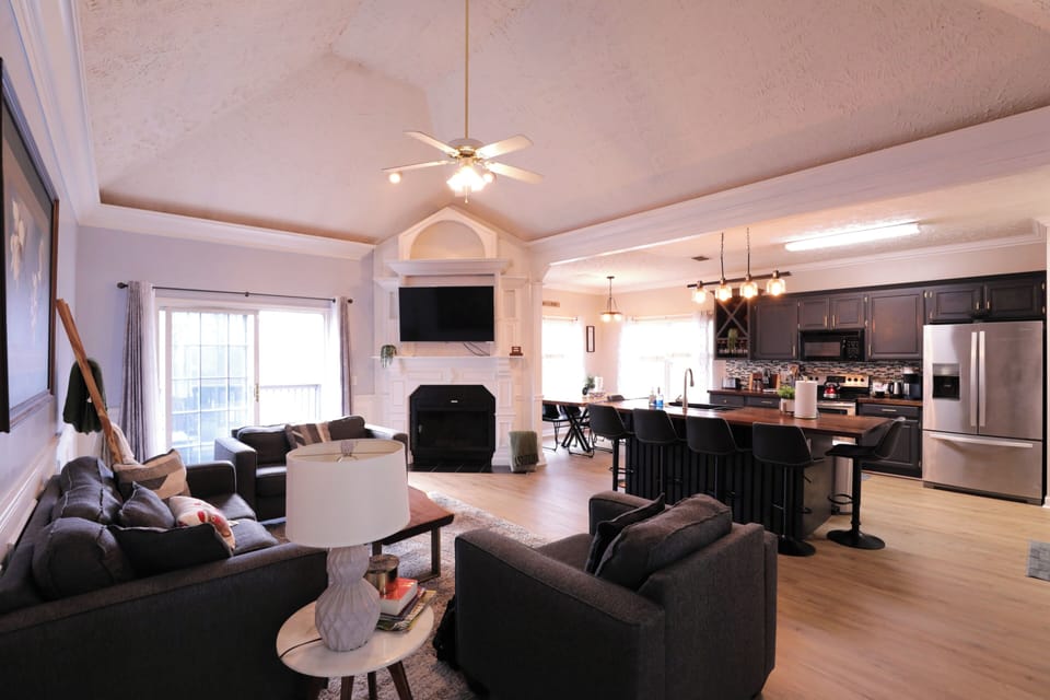 Bright, cozy open living area with comfy seating, Smart TV, and kitchen island.
