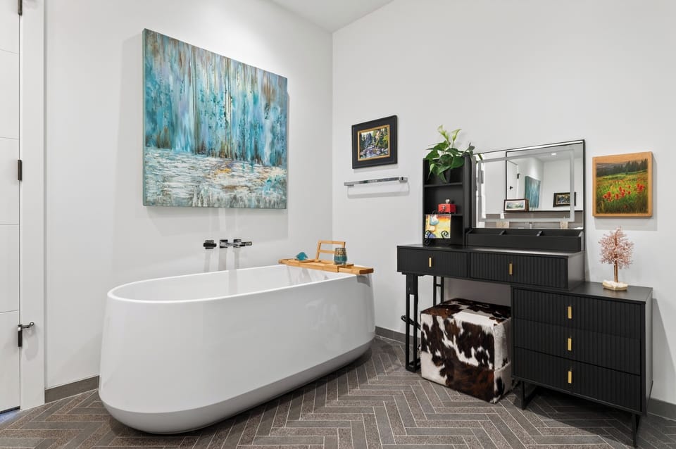 The primary bedroom's ensuite features a shower and a soaking tub.