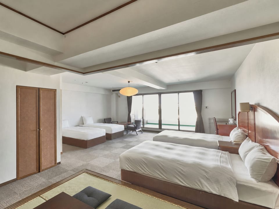 Deluxe Quadruple Room, Balcony, City View | Desk, WiFi (free), bed sheets