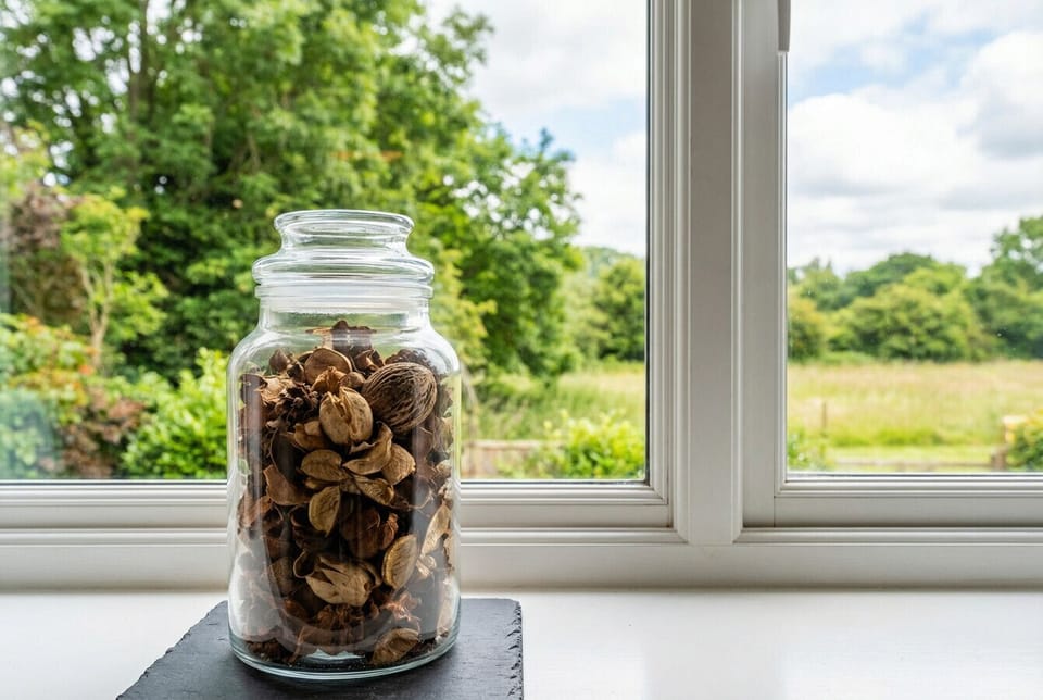 Lush garden greenery frames the window view, a gentle reminder of the natural beauty just outside your door.