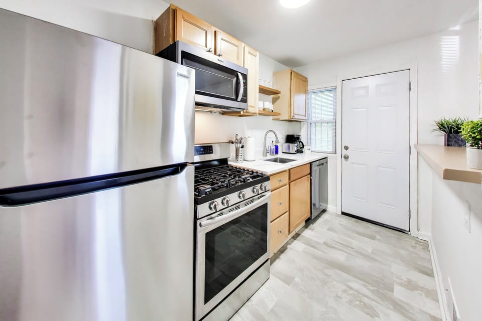 Full Kitchen with fun coffee mugs and wine glasses - all new appliances!