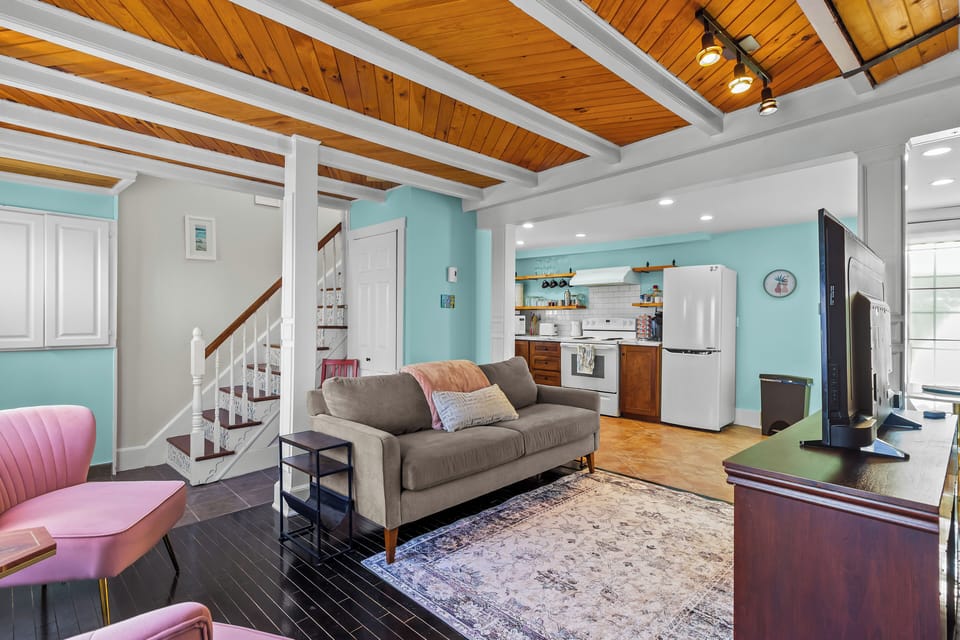 Open-concept living space with cozy sofa and easy kitchen access