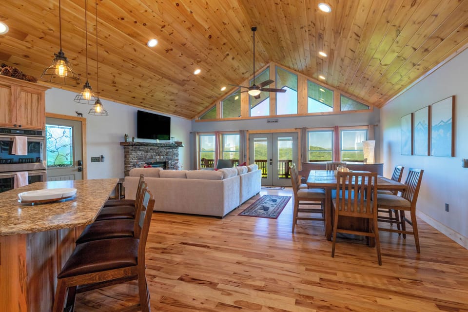 Open-Concept Living, Dining and Kitchen Area - Main level great room with soaring ceilings, hardwood floors, and mountain views.