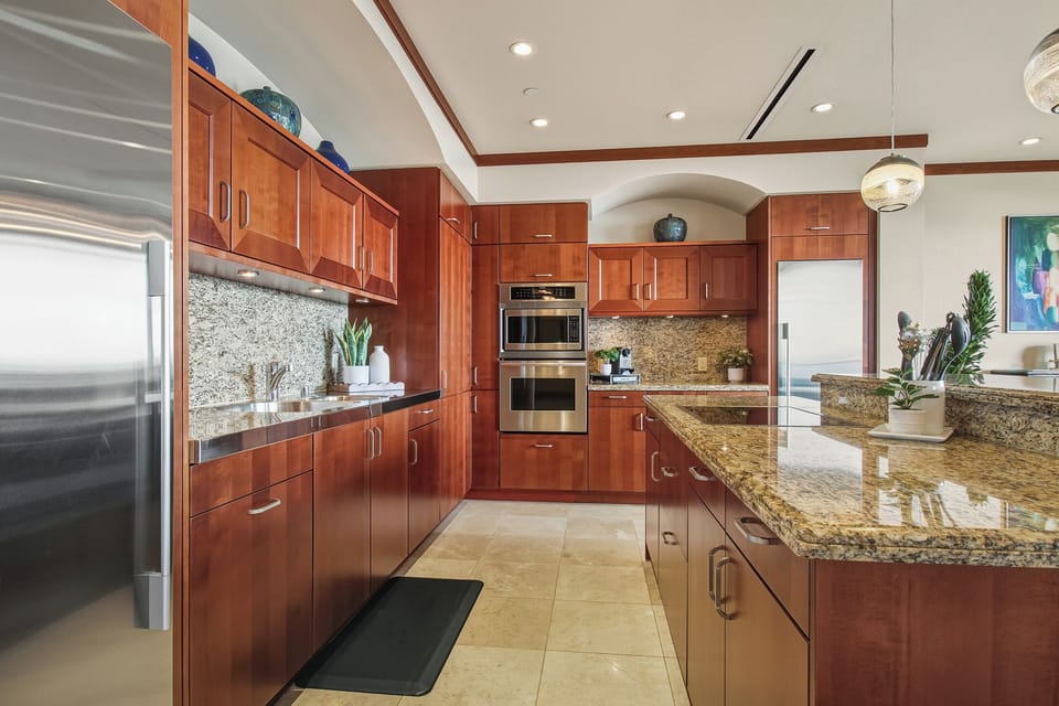 Your gourmet kitchen awaits with granite counters, cherry cabinets, and premium appliances
