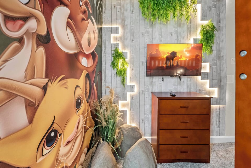 Step into a playful entryway adorned with vibrant animal artwork that instantly brings joy. The warm wood tones of the chest draw the eye, complemented by lush greenery and soft lighting that create a welcoming atmosphere.