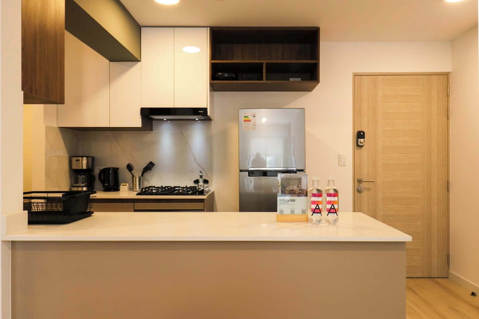 Modern kitchen with stove, oven, and fridge, perfect for preparing meals.