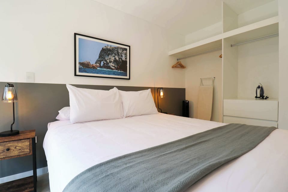 Spacious bedroom with storage shelves and elegant décor.