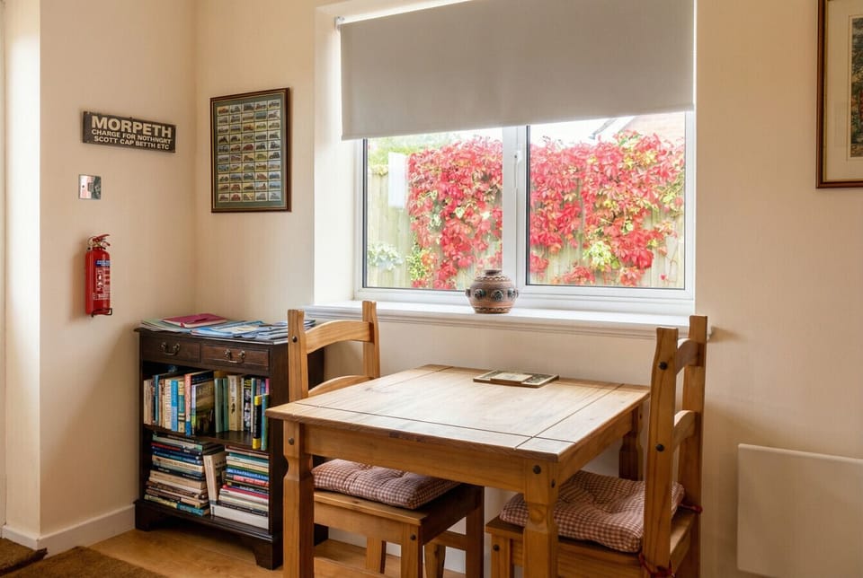 The dining nook with a Morpeth railway print and bookshelf full of local guides feels like home.