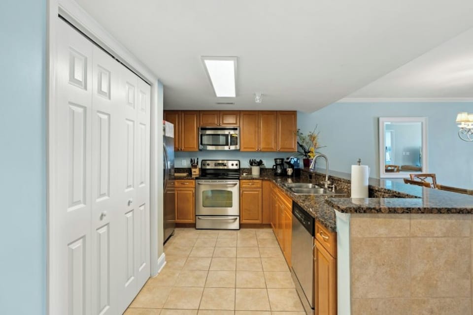 The spacious kitchen is updated & well stocked for preparing family meals.