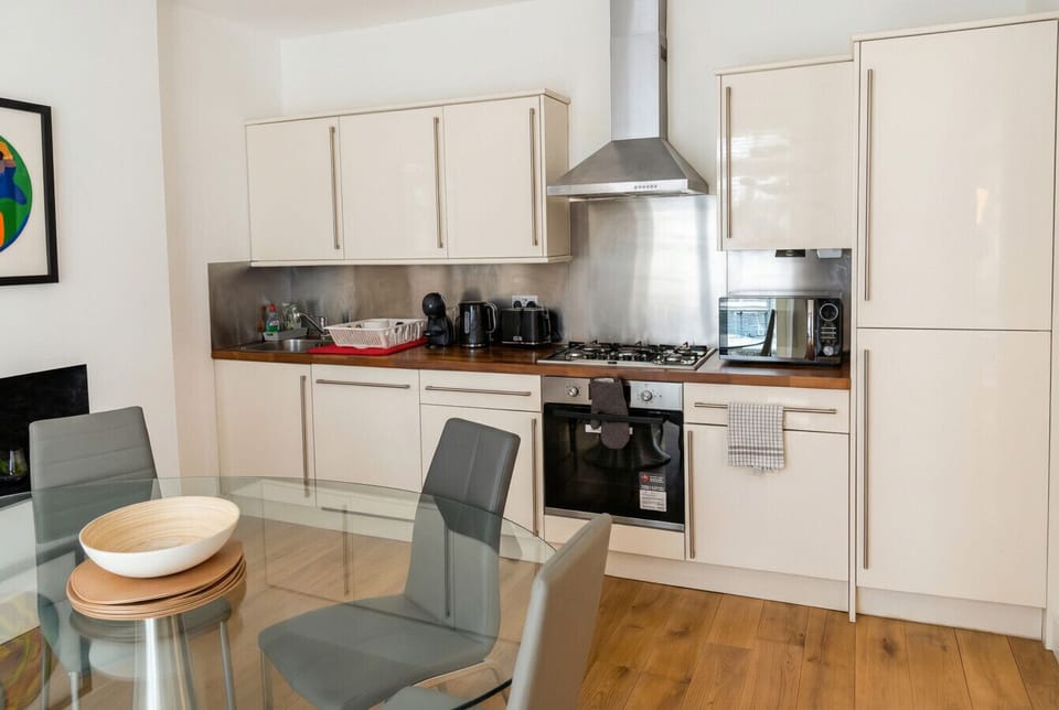 Well-equipped kitchen with gas hob, stainless steel splashback and Nespresso machine for morning coffee.