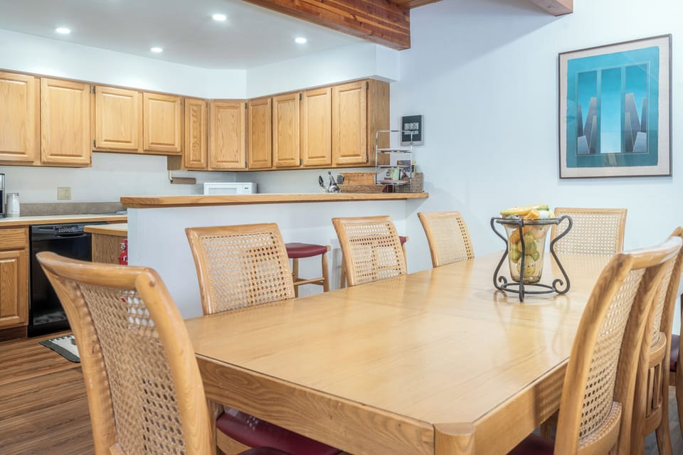 Gather around your spacious dining table where warm wood tones and natural textures create the perfect spot for memorable meals together.