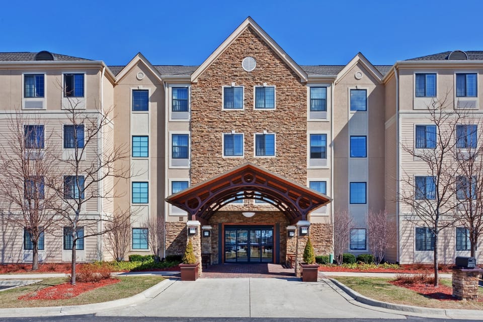 Step inside the elegant entrance, framed by stone and wood features, welcoming you for a refreshing escape.