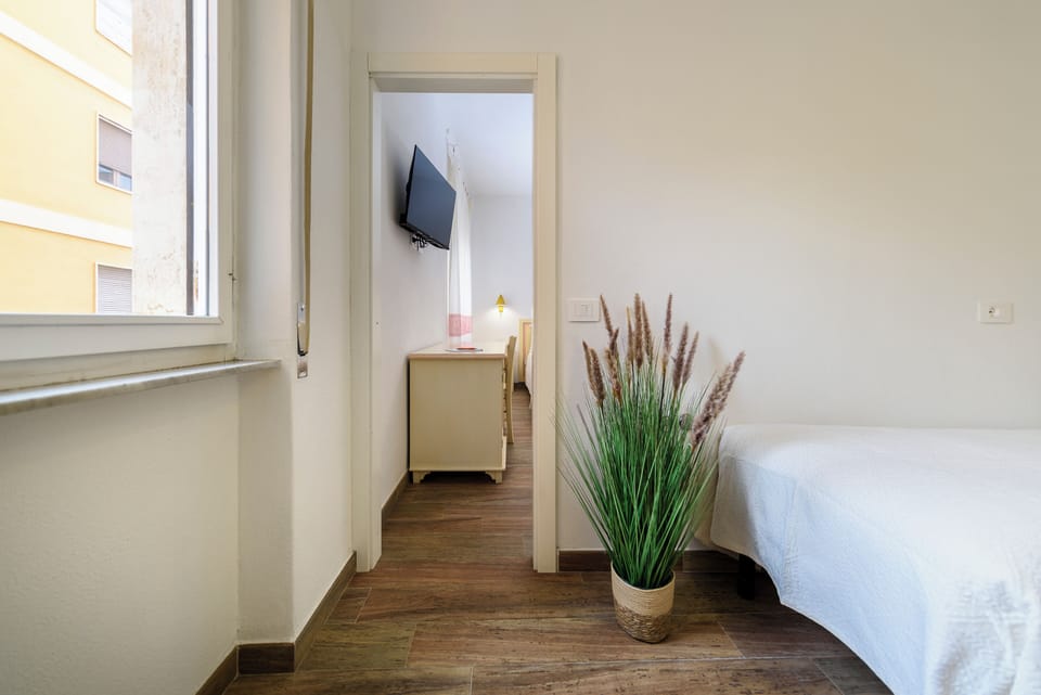 Family Quadruple Room | In-room safe, desk, laptop workspace, blackout drapes