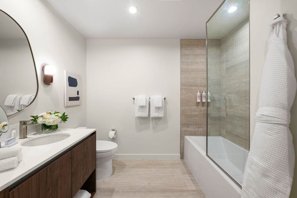Deep soaking tub, rainfall shower, Malin+Goetz amenities.