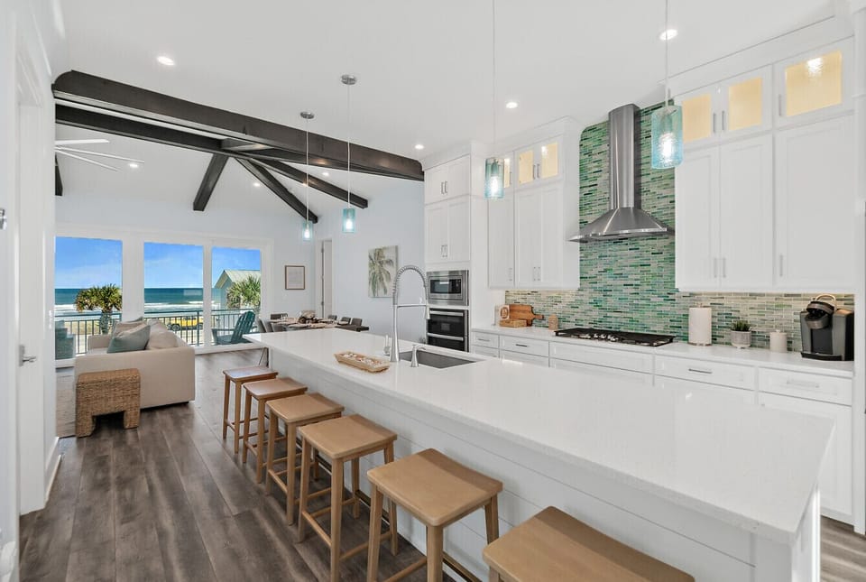 Open kitchen with island seating and ocean views from the main living level
