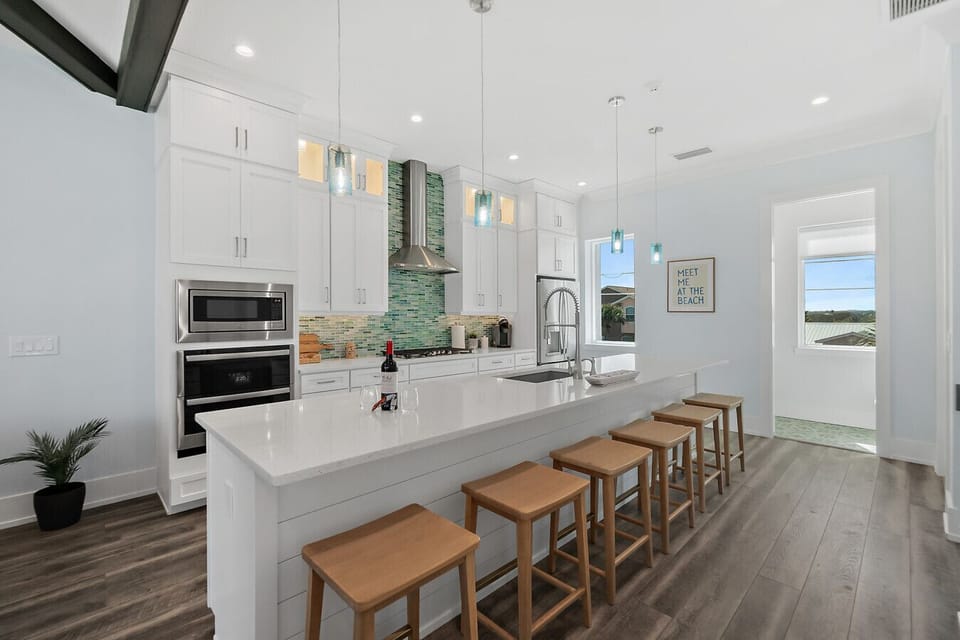 Modern kitchen with large island seating and open layout connecting to the living area