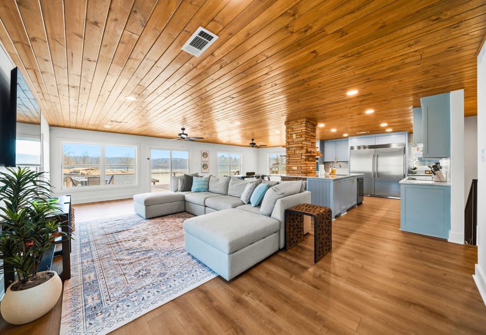 The living room offers plenty of cozy seating, making it the perfect place to unwind, watch a movie, or gather for conversation while natural light fills the space.