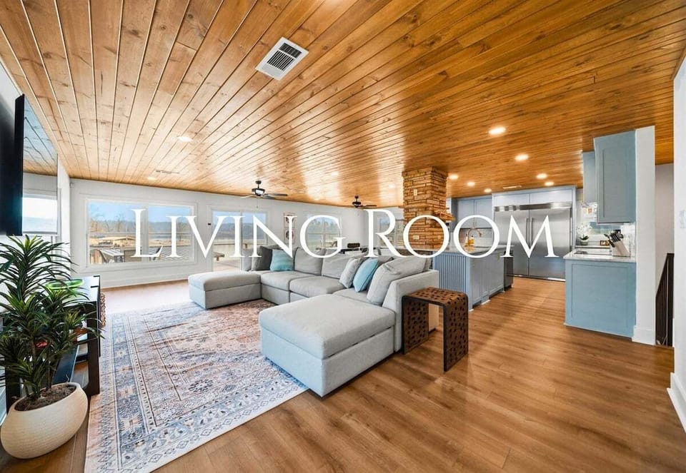 The living room offers plenty of cozy seating, making it the perfect place to unwind, watch a movie, or gather for conversation while natural light fills the space.