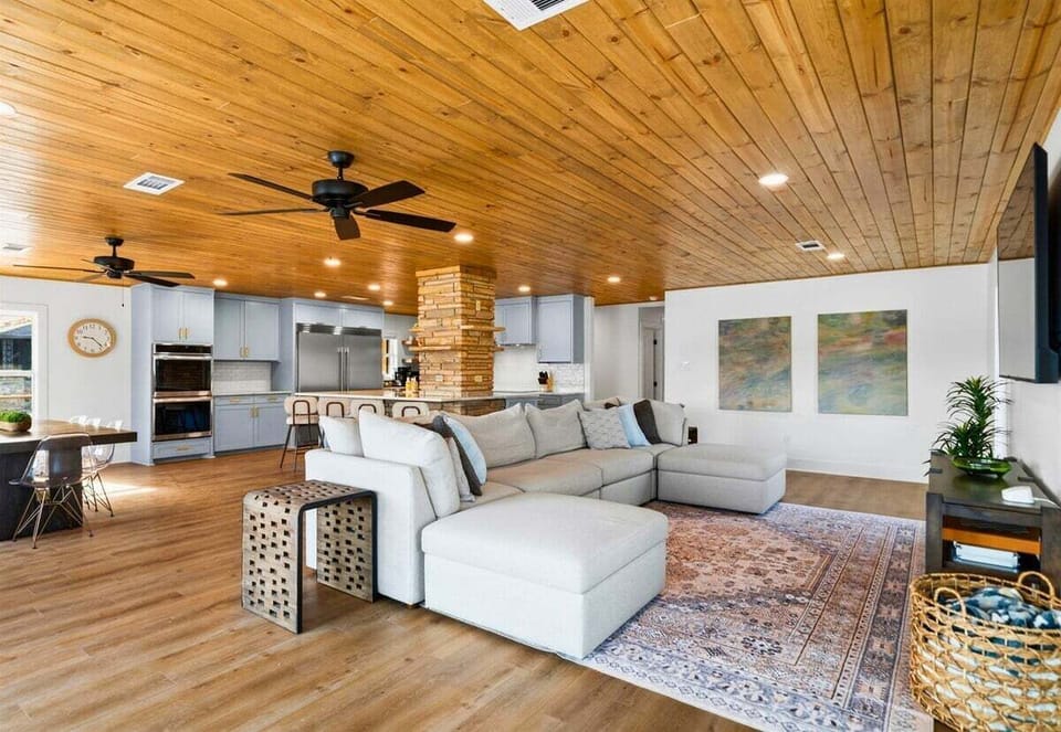 The open floor plan flows effortlessly between the living room and kitchen, creating a comfortable space for gathering, cooking, and spending time with family and friends.