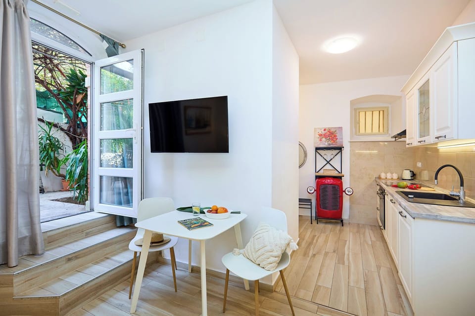 Step from the bright, modern studio into the shared courtyard, where your private table awaits for an al fresco meal.