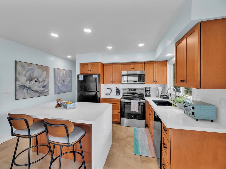 Update kitchen with quartz waterfall edge on both sides,  updated appliances etc