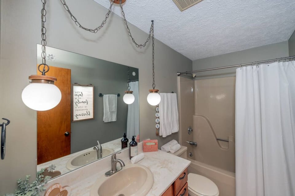 Bathroom Retreat: Enjoy contemporary design with bright lighting and stylish decor for relaxation!