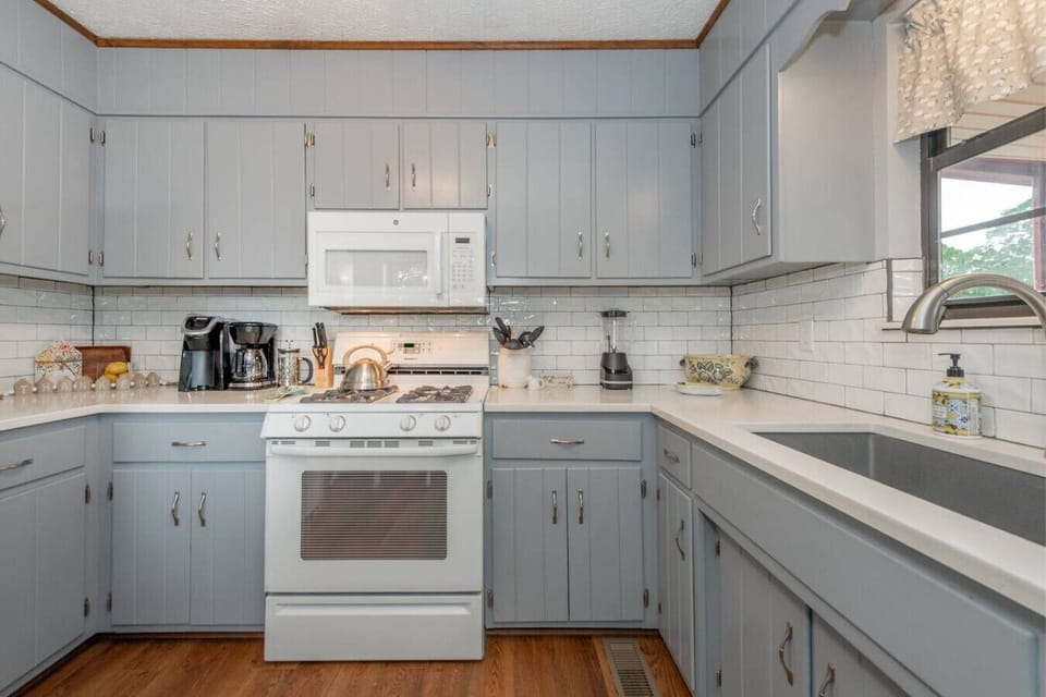 Modern Kitchen: Whip up delicious meals in this sleek space with elegant cabinetry and light-filled views!