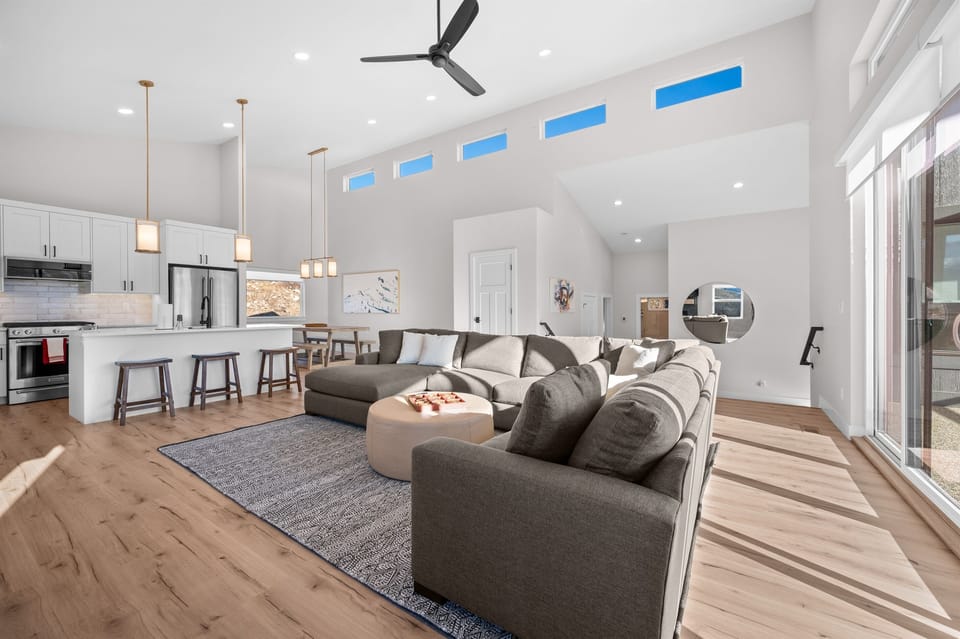 Gourmet kitchen with quartz countertops, stainless appliances, and bar seating for four.