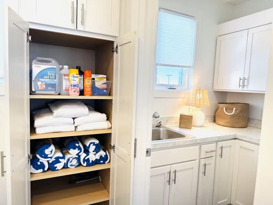 Bathroom cabinet stocked with Beach towels, First Aid Kit, Sunscreen/Bug spray