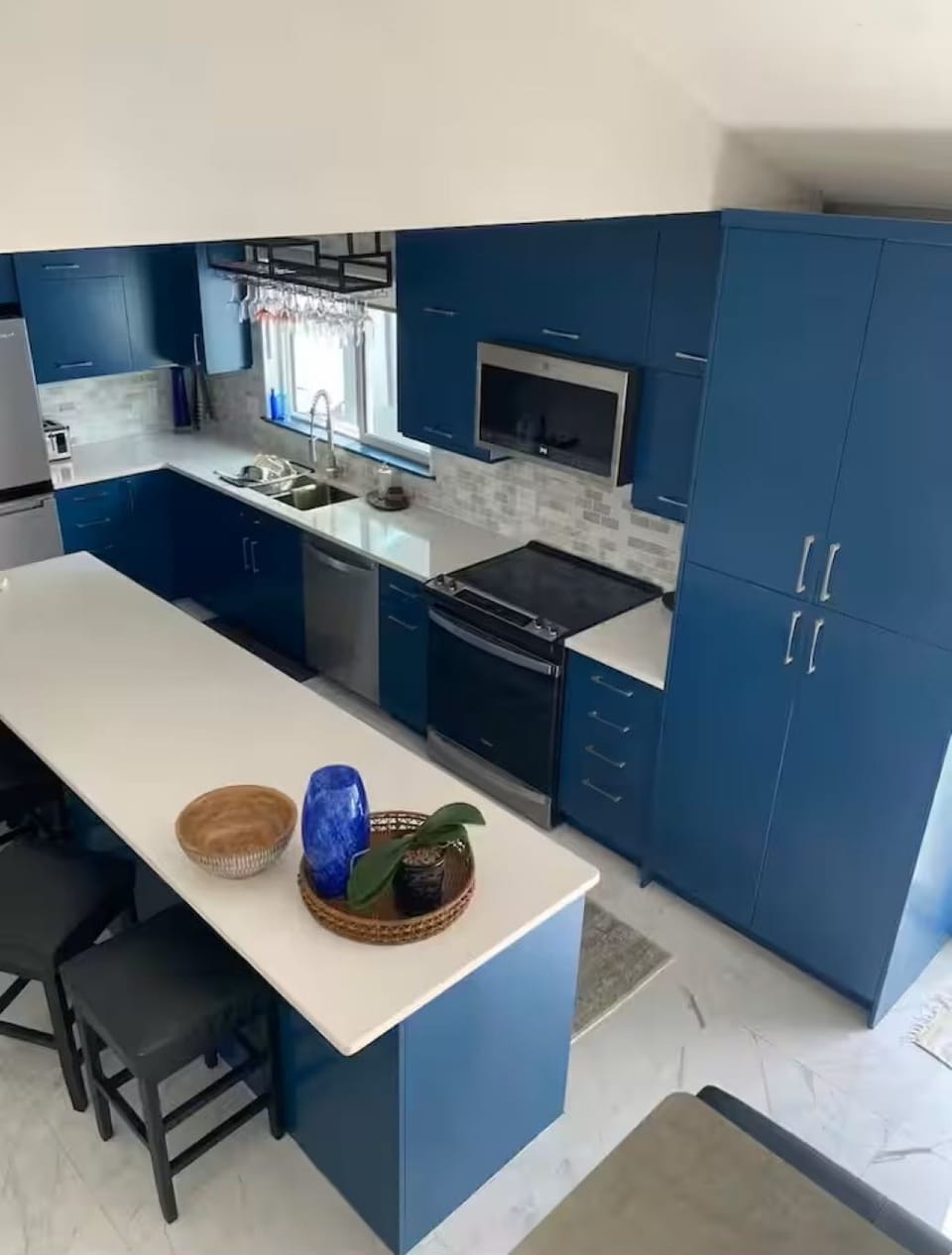 Spacious full kitchen with everything you need. View from living room.