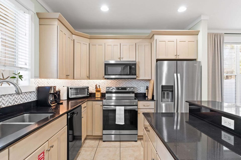 Modern appliances make cooking simple and efficient, with plenty of counter space for prep and serving.