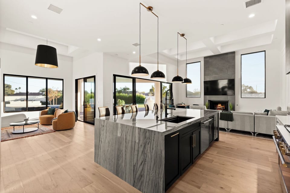 Stunning great room featuring a designer kitchen and cozy fireplace.