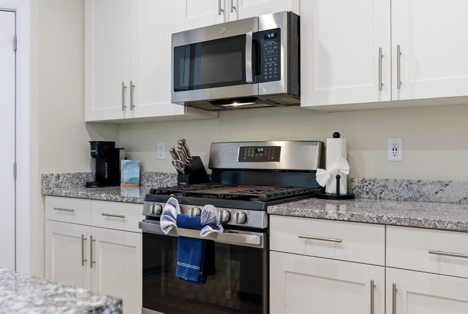 Kitchen: Sleek appliances and granite countertops invite culinary adventures in style!