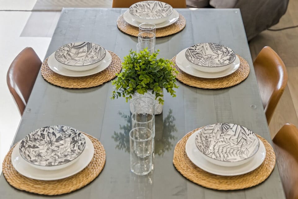 Dining Area: Stylish table settings with artistic plates await your culinary adventures!