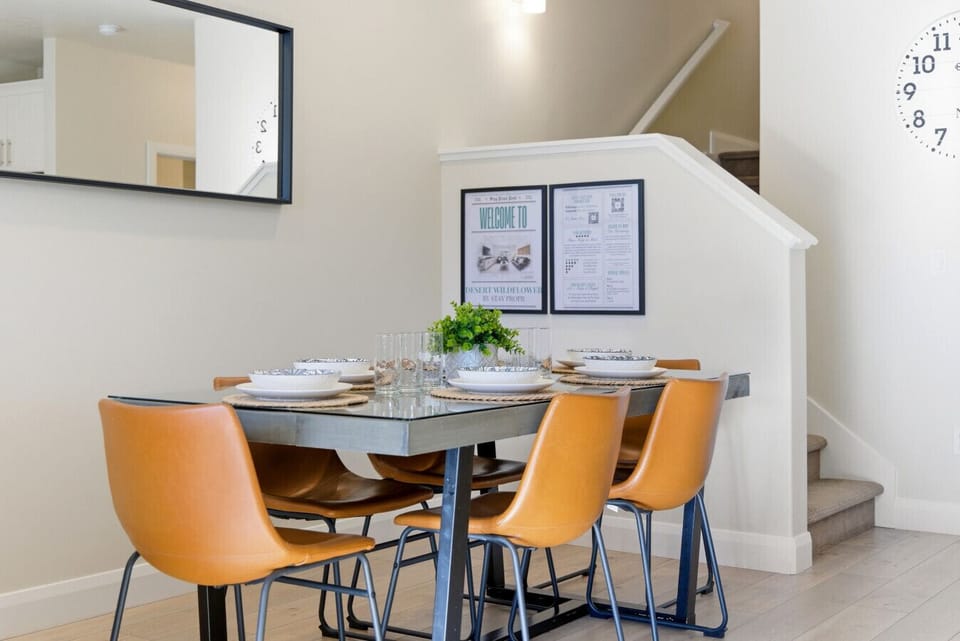 Dining Area: Stylish gatherings await at this modern table with vibrant seating and chic decor!