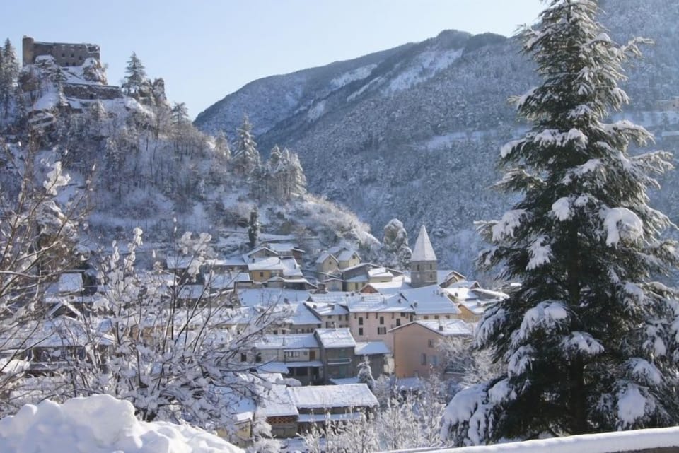Breathtaking mountain view over the charming snow-covered village of Guillaumes.
