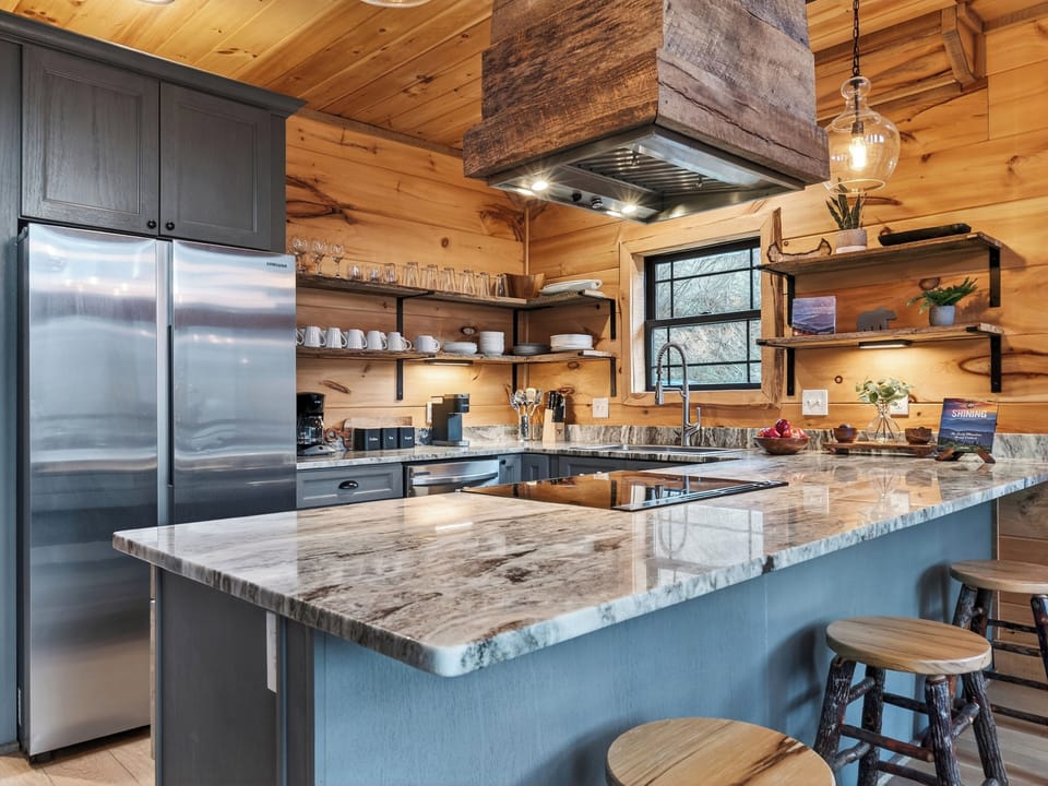 Well-equipped kitchen with a large island, bar seating, and plenty of room to cook together.